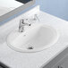 A white American Standard drop-in sink with a center hole.