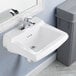 A white American Standard wall-mount lavatory sink with a silver faucet.