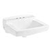 A white American Standard wall-mount bathroom sink with three holes.