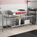 A Steelton stainless steel equipment stand with a pot on a stove.