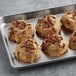 Preformed David's Cookies Decadent Pumpkin White Chocolate Pecan Cookie dough on a baking tray.