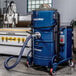 A blue and black Goodway Technologies wet/dry vacuum machine with a hose.