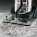 A Goodway Roll-Vac attachment with a brush on a vacuum hose.