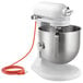 A white KitchenAid bowl lift countertop mixer with standard accessories.