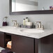 A bathroom with a Delta deck-mount lavatory faucet with two sinks and a mirror.