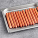 A tray of Sabrett Skinless Beef Franks on a counter.