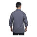 A man wearing a Uncommon Chef long sleeve chef coat with a slate mesh back.