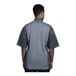 A man wearing a Uncommon Chef Florence short sleeve chef coat with a grey mesh back.