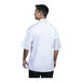 A man wearing a white Uncommon Chef Bari short sleeve chef coat.