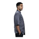 A man wearing a Uncommon Chef Florence grey short sleeve chef coat with a grey mesh back.