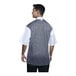 A man wearing a white Uncommon Chef Brac chef coat with a black and grey mesh back.