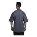 A man wearing a Uncommon Chef slate short sleeve chef coat with a grey mesh back.