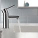 A Delta deck-mount lavatory faucet with water running out of it.