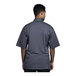 A man wearing a Uncommon Venice short sleeve chef coat with a grey mesh back.