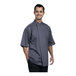 A man wearing an Uncommon Chef slate grey short sleeve chef coat with a grey mesh back.