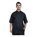 A man wearing a Uncommon Chef black chef coat with silver mesh.