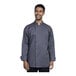 A man wearing a Uncommon Chef Turin long sleeve chef coat with a mesh back.