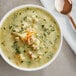 A bowl of Vienna Beef Bistro Savory Chicken Sausage Soup with potatoes, spinach, and meat.