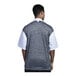 A man wearing an Uncommon Chef white short sleeve chef coat with a black and grey mesh back.