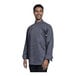 A man wearing a Uncommon Chef grey long sleeve chef coat with slate mesh back.