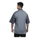 A man wearing a short sleeve Uncommon Chef Slate chef coat with grey heather mesh back.