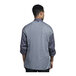 A man wearing a Uncommon Chef Roma long sleeve chef coat with grey mesh back.