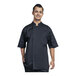 A man wearing a black Uncommon Chef short sleeve chef coat with black mesh back smiling.