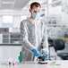 A person wearing Lavex white coveralls, a mask, and gloves.