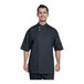 A man wearing a black Uncommon Chef Bari short sleeve chef coat.