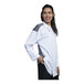 A woman wearing an Uncommon Chef white long sleeve chef coat with black mesh details.