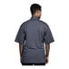 A man wearing a Uncommon Chef Venice short sleeve chef coat with a grey mesh back.