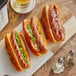 Three Vienna Beef natural casing beef franks on a white plate.