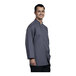 A man wearing an Uncommon Chef Treviso chef coat with slate mesh back.