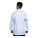 A man wearing a white Uncommon Chef long sleeve chef coat with white mesh on the back.