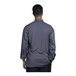 The back of a man wearing a Uncommon Chef Pisa Slate Mesh Long Sleeve Chef Coat.