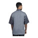 A man wearing a Uncommon Chef Modena slate chef coat with a grey mesh back.