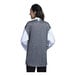 A woman wearing a Uncommon Chef white and black 3/4 sleeve chef coat with a black mesh back.