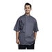 A man wearing a Uncommon Chef Bari short sleeve chef coat with a slate mesh back.