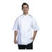 A man wearing a Uncommon Chef white short sleeve chef coat with black mesh back.