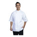 A man wearing a Uncommon Chef white short sleeve chef coat with white mesh back.