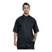 A man wearing a Uncommon Chef black short sleeve chef coat with silver mesh details.