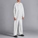 A man wearing a white Lavex coverall with elastic wrists and ankles.