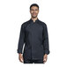 A man wearing a black Uncommon Chef long sleeve chef coat with a silver mesh back smiling.