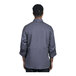 A man wearing a Uncommon Chef slate grey long sleeve chef coat with a slate grey half mesh back.