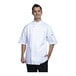 A man wearing a Uncommon Chef white short sleeve chef coat with white mesh back.