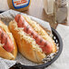 Two Sabrett Knockwurst sausages with sauerkraut on top in a basket.