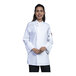 A woman wearing a white Uncommon Chef long sleeve chef coat with white mesh sleeves.