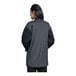 A woman wearing an Uncommon Chef black and grey long sleeve chef coat with mesh back.