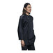 A woman wearing a black Uncommon Chef Solta chef coat with silver mesh.