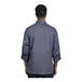 A man wearing a Uncommon Chef slate grey long sleeve chef coat with a half mesh back.